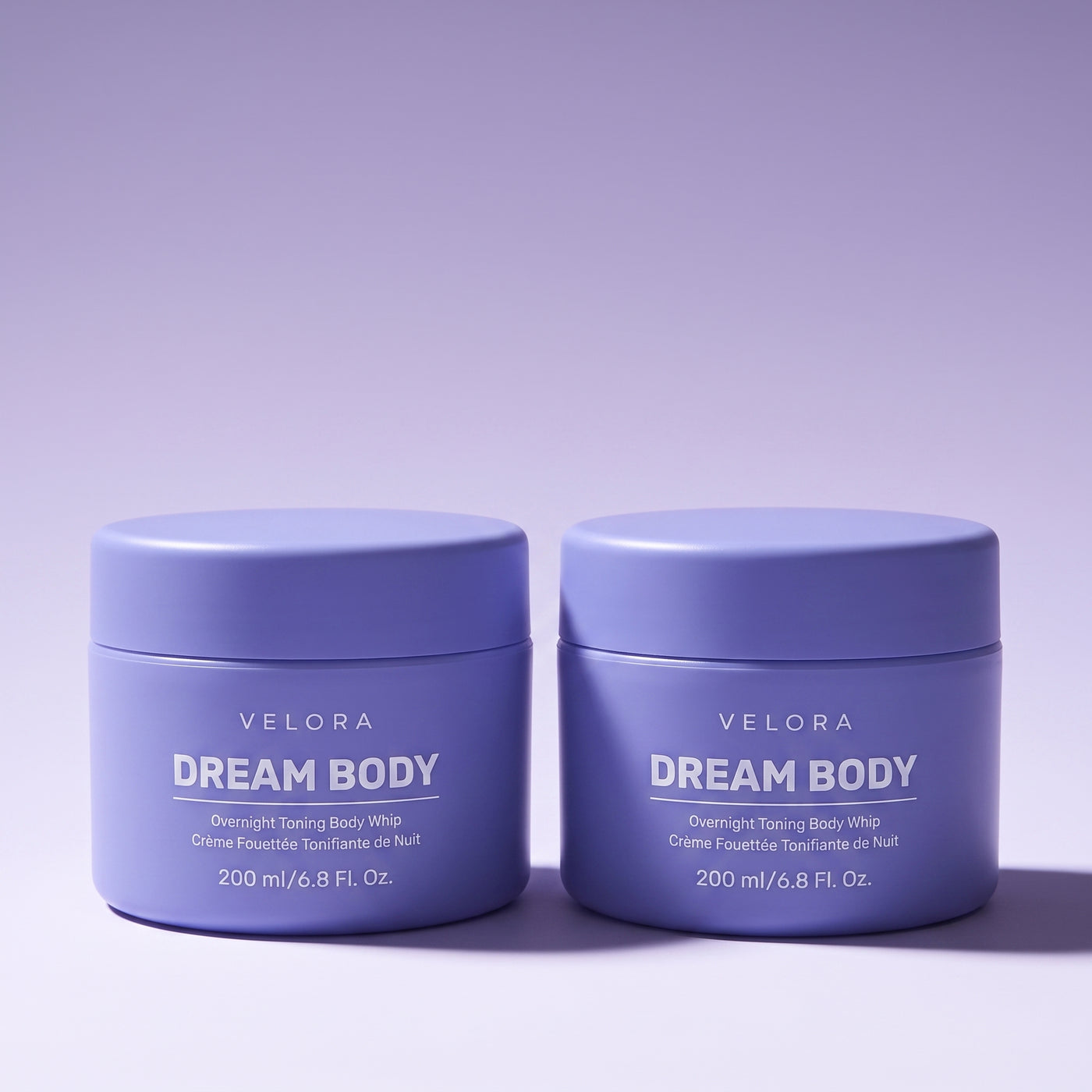 Velora Dream Body crème jar bundle on a purple studio set
